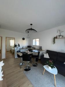 a living room with a couch and a table at Le nid douillet de Clermont ferrand in Clermont-Ferrand