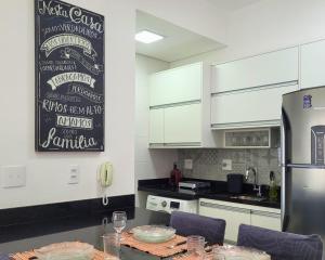 a kitchen with a table with a chalkboard on the wall at Book Santos Unlimited 1216 - Vista Lateral do Mar in Santos
