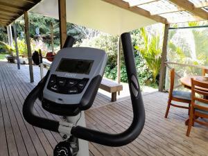 an exercise machine on a deck with a table at Cosy Unit 3 bdrms Two dogs live onsite with me in Waipapa