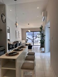 a kitchen and living room with a large island at Elegant Modern Tiny Home in San Miguel