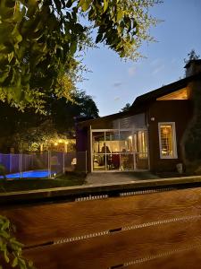 a house with a lot of windows in the night at Die Ville VGB in Villa General Belgrano
