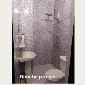 een badkamer met een douche, een toilet en een wastafel bij Fôhundi home in Abidjan