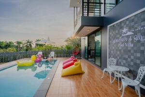 a swimming pool with inflatables in a building at Mountain & Sea Pool Villa ทับสะแก in Prachuap Khiri Khan