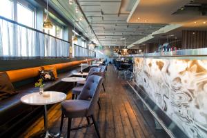 a row of tables and chairs in a restaurant at Mornington Hotel Bromma in Stockholm
