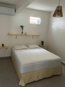 Postel nebo postele na pokoji v ubytování Casa Caraïbe