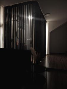 a dark room with a black curtain and a table at The cave in Netanya +1 photo