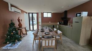 a kitchen with a table and a christmas tree in it at Domaine Caloin - SPA in Echinghen