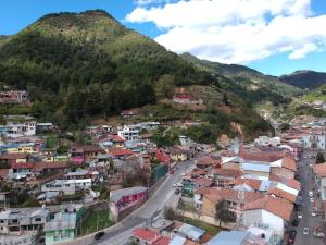 an aerial view of a town in front of a mountain at Alojamiento Ecológico Angangueo in Mineral de Angangueo