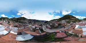 an aerial view of a town with buildings and mountains at Alojamiento Ecológico Angangueo in Mineral de Angangueo