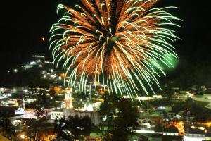 a fireworks display over a city at night at Alojamiento Ecológico Angangueo in Mineral de Angangueo +1 photo