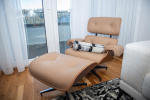 a pair of chairs in a room with a window at Royal Premium by Vucko Jahorina Serviced Apartments in Jahorina