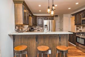 a kitchen with wooden counter tops and wooden stools at Camelback Ski Mts,Firepit, Hottub,Kalahari WaterPark,Linens! in Cresco