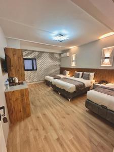 a large hotel room with two beds and a television at Skymoon Istanbul Airport Hotel in Arnavutköy