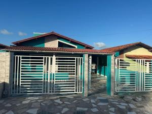 a house with a gate in front of it at Lessa imob in Salinópolis