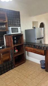 a kitchen with a counter top with a microwave at Suit Junior Emano 410 in Ixtapa