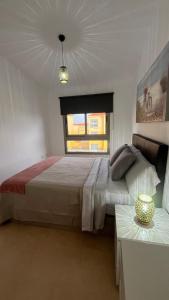 a bedroom with a large bed and a window at Casa Yanelis in Antigua +18 photos