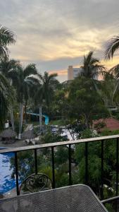 a view from the balcony of a resort with palm trees at Suit Junior Emano 410 in Ixtapa