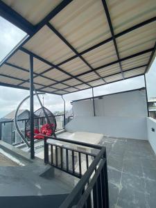 a balcony with a bed and a swing at Villa Kenangan in Tlekung