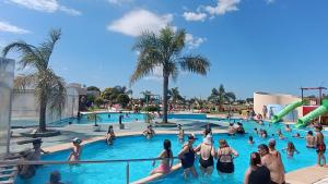 a group of people in a swimming pool at a resort at Cabañas MYM en Termas de Basavilbaso in Basavilbaso