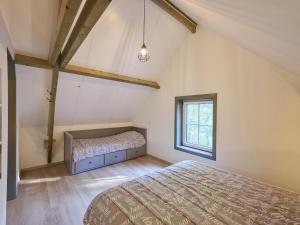 a bedroom with a bed and a window at Bosbeertje 43 45 in Boerdonk