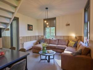 a living room with a couch and a table at Bosbeertje 43 45 in Boerdonk