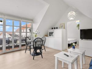 a kitchen and dining room with a table and chairs at Cozy Retreat in Lokken - By Traum Ferienwohnungen in Løkken