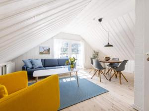 a living room with a blue couch and a table at Charming Retreat in Lonstrup - By Traum Ferienwohnungen in Hjørring