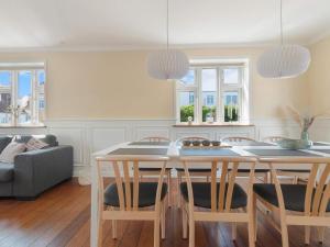 a kitchen with a table and chairs and a couch at Spacious Retreat in Lokken - By Traum Ferienwohnungen in Løkken +14 photos