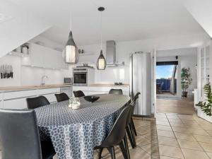a kitchen and dining room with a table and chairs at Luxury Retreat in Lokken - By Traum Ferienwohnungen in Løkken