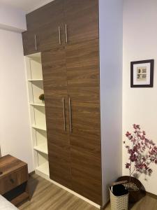 a bedroom with a large wooden cabinet in a room at Cómodo y confortable Estudio in Cochabamba