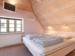 two beds in a room with a wooden ceiling at Cozy Coastal Retreat - By Traum Ferienwohnungen in Løkken