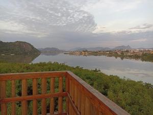 a view of a river from a wooden balcony at Refúgio de Piratininga 105 in Niterói