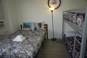 a bedroom with a bed and a bunk bed at Waikiki Canal Family Room 6person in Honolulu +21 photos