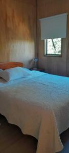 En eller flere senge i et værelse på Casa Puratich