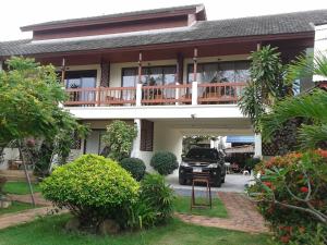 a truck parked in front of a house with a balcony at The Waterfront Hotel at Fishermans Village in Bophut 