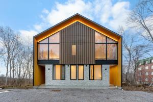 a house with a large window on the front of it at AOYAMA VILLA in Kombu