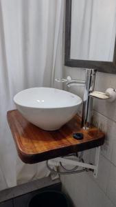 a white sink sitting on a wooden counter in a bathroom at Casa Mar de Cobo in Mar de Cobo +22 photos