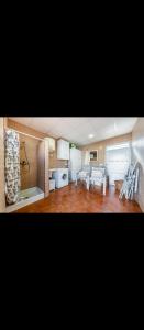 a kitchen and a living room with tables and chairs at Torrebeach in Torre de la Horadada