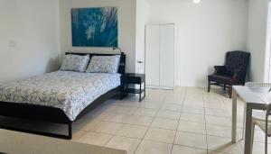 a bedroom with a bed and a table and a chair at Sunshine Cove in Lake Forest