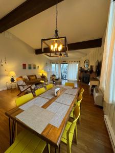 a dining room and living room with a table and chairs at Newly Remodeled Mid-Century Modern Lake Condo in Lake Geneva