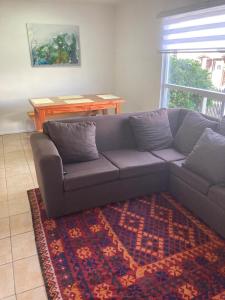 a living room with a couch and a table at Casa Relmu in Puerto Varas