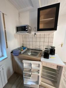 a small kitchen with a sink and a microwave at Monteurzimmer 1 - Little Afrika in Minden +11 photos