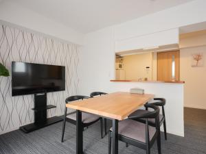 a conference room with a wooden table and chairs at Ito House in Tokyo