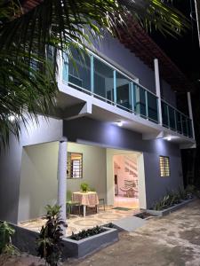 a house with a table in front of it at Residência Naiote in Japaratinga