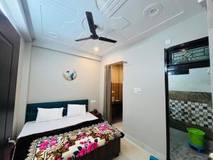 a bedroom with a bed and a ceiling fan at Vedshree in Prayagraj