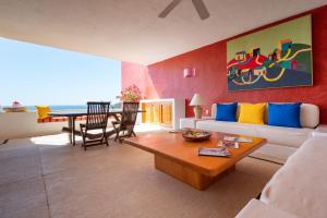 a living room with a white couch and a table at Casitas in Careyes in Careyes