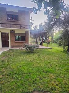 a house with a lawn in front of it at Cabañas El Rosedal in San Rafael