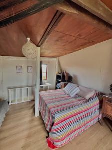 a bedroom with a bed and a wooden ceiling at Cabaña Luna Rubia in La Pedrera