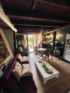 a living room with a couch and a table at Cabaña Luna Rubia in La Pedrera