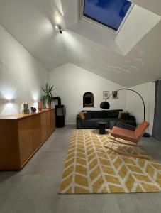 a living room with a couch and a rug at Chiemgau One in Marquartstein